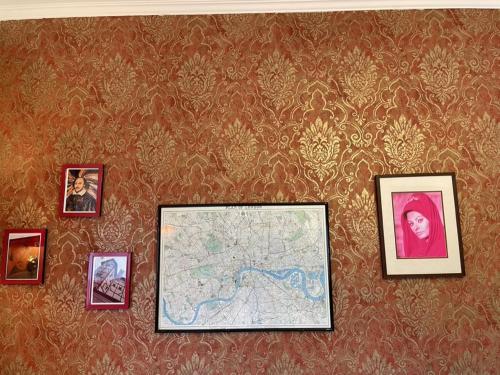 a wall with pictures and a map on it at Söruper Hof in Sörup