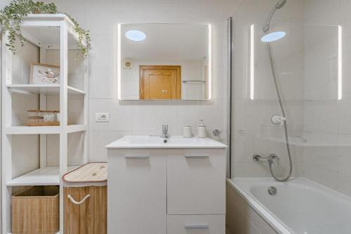 a white bathroom with a sink and a bath tub at Playa La Arena 2 Bed Apartment in Puerto de Santiago