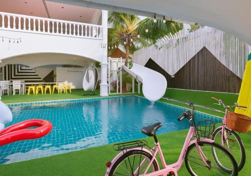 two bikes parked next to a swimming pool at Luxury 5 Bedroom Funplace Pool Villa in Pattaya in Na Jomtien