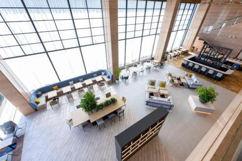 an overhead view of a lobby with tables and chairs at ANA Holiday Inn Iwate Kitakami by IHG in Kitakami
