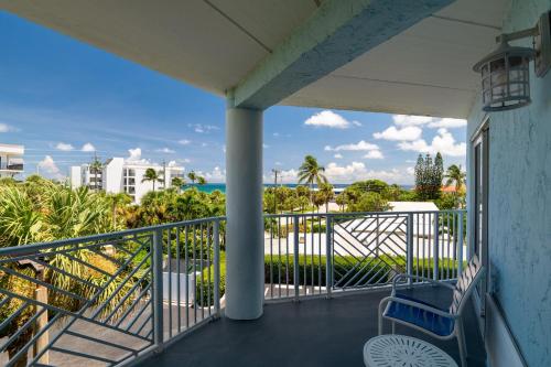 a balcony with a chair and a view of the ocean at Holiday Inn Express- North Palm Beach and IHG Hotel in Juno Beach