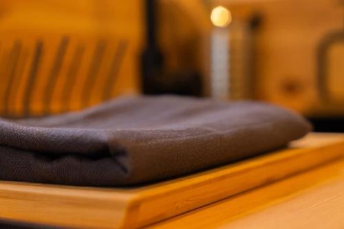 a brown pillow sitting on top of a wooden table at Lodge en Nature - 30 min Saint-Emilion - Salle de bain à l'italienne in Mouliets-et-Villemartin