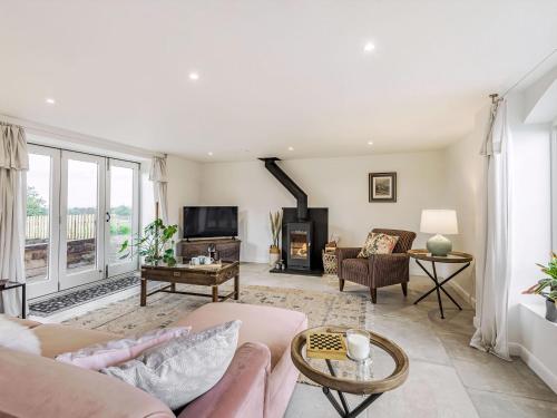 a living room with a couch and a tv at The Drift House in Malpas