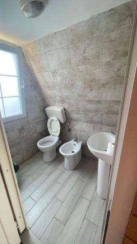 a bathroom with two toilets and a sink at Shtepia Druri Sokol Lulaj in Lezhë