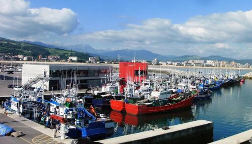 a group of boats docked in a harbor at Alojamientos Dima Costa in Laredo
