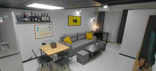 a living room with a couch and a table at Nitro Inn 3 Premium - Wine Tasting - Souvenir - Art Gallery - Private Guided Tours - Relaxing - Romantic in Skopje