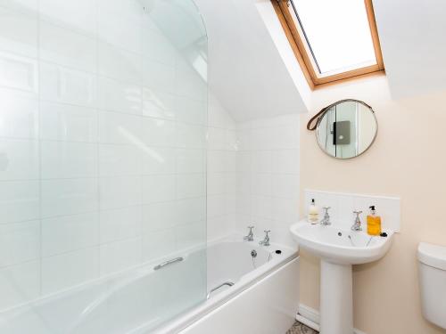 a bathroom with a tub and a sink at The Helmsley Retreat in Helmsley