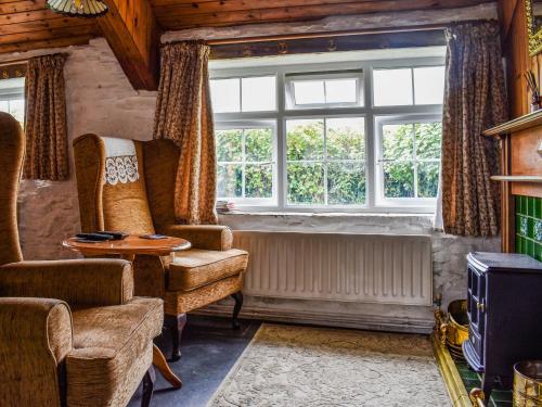 a living room with a chair and a window at Skyber - Uk50374 in Camelford
