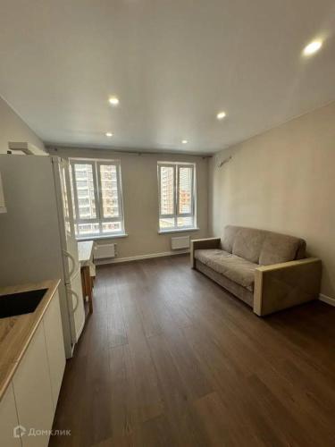 a large living room with a couch and two windows at Apartmány U hrušky in Louny