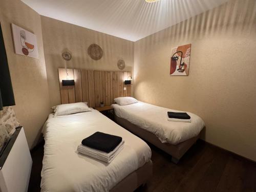 a small room with two beds in a room at Domaine de Brise Bois - Chambres & Gîtes in Rouzède