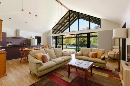 a large living room with a couch and a table at Purple Shore Spacious Family Stay Near Busselton Jetty in Busselton