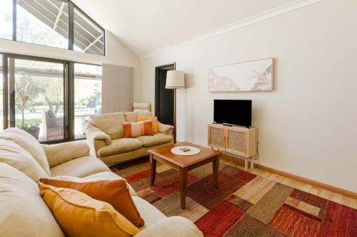 a living room with a couch and a table at Purple Shore Spacious Family Stay Near Busselton Jetty in Busselton
