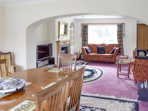 a living room with a table and a couch at Glebe Farm Cottage in Hornby