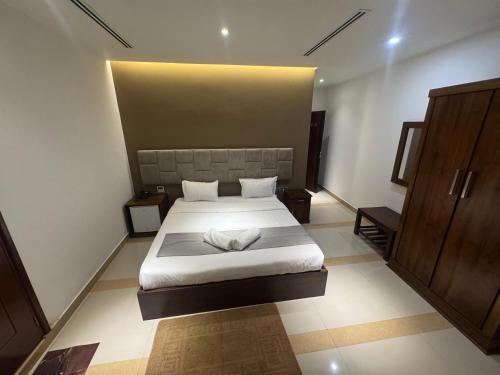 a bedroom with a large bed with white sheets at The Auresta Colombo in Colombo