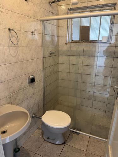 a bathroom with a toilet and a shower and a sink at Casa Diamantina 3 in Diamantina