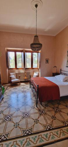 a bedroom with a large bed with a red blanket at Masseria Cesarina B&B in Castellana Grotte