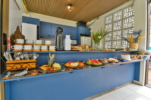 a buffet with many plates of food on it at Mar de Bombinhas - Centro in Bombinhas