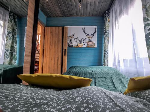 a bedroom with a bed with a yellow bowl on it at Ostoja Karkonoska in Podgórzyn