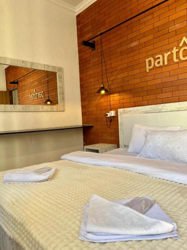 a bedroom with two beds with towels on them at Vernisa hotel in Tbilisi City