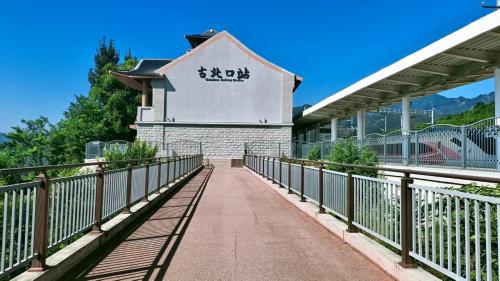 a bridge in front of a building at Jinshanling Great Wall聚友缘民宿 in Gubeikou
