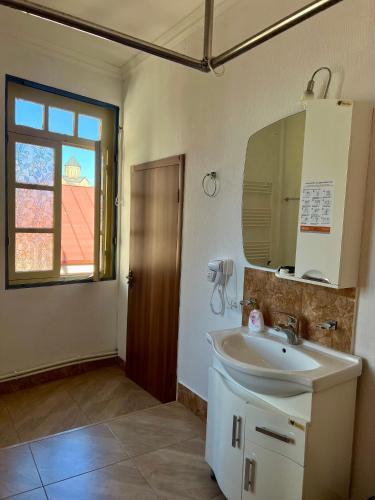 a bathroom with a sink and a mirror at Vernisa hotel in Tbilisi City