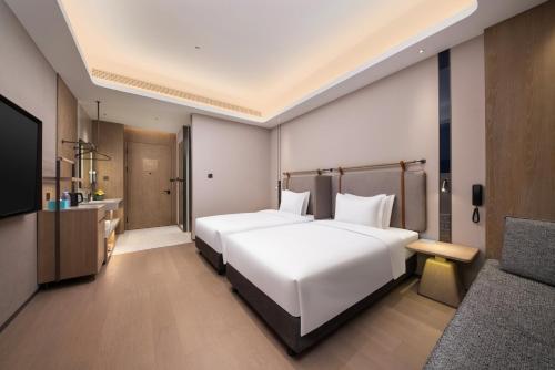 Postel nebo postele na pokoji v ubytování Holiday Inn Express Suzhou North Station by IHG