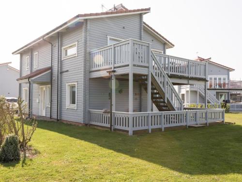a large house with a large deck and a porch at Broad Reach - 28121 in Fritton Norfolk