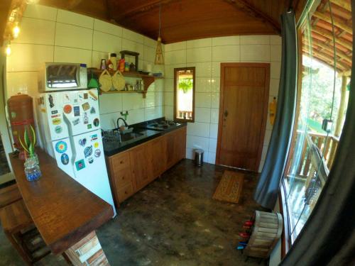 an overhead view of a kitchen with a white refrigerator at Chalé Biribó in Conceição do Mato Dentro