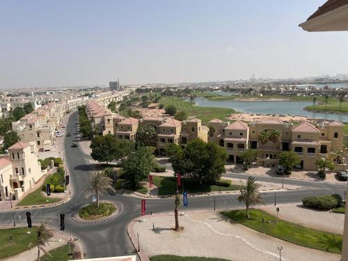 an aerial view of a city with houses and a street at Elegant One-bedroom apartment in Al Hamrah village in Ras al Khaimah