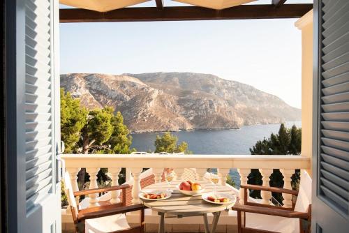 a balcony with a table and a view of the ocean at Endless Blue, Your Seaside Escape in Plati Gialos in Kamári