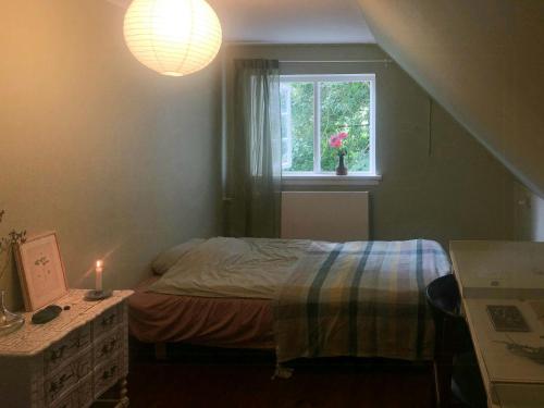a small bedroom with a bed and a window at Forest Ranger's House With Sea View In Kalvehave in Kalvehave