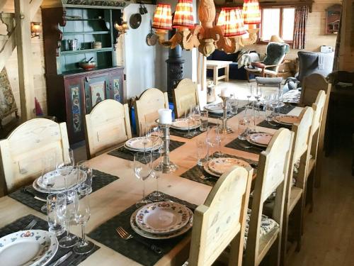 a long table with glasses and plates on it at Spacious Family Cabin With Views In Hafjell in Hunder