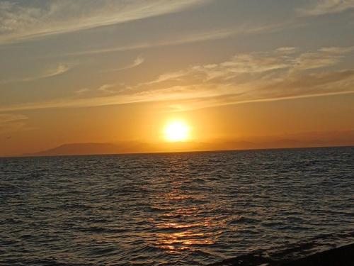 a sunset over the ocean with the sun setting at Sendikala Lombok in Pancor
