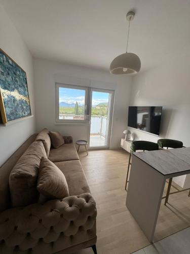 a living room with a couch and a table at Apartman Katamar in Ljubuški