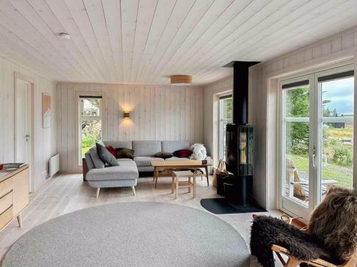a living room with a couch and a table at Family Cabin With Views In Lygnalia in Jaren