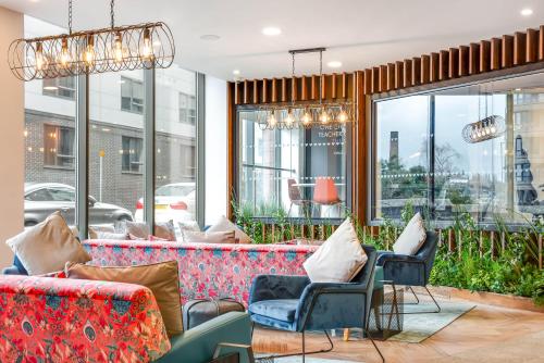 a lobby with couches and chairs and windows at The Edge in Central Station