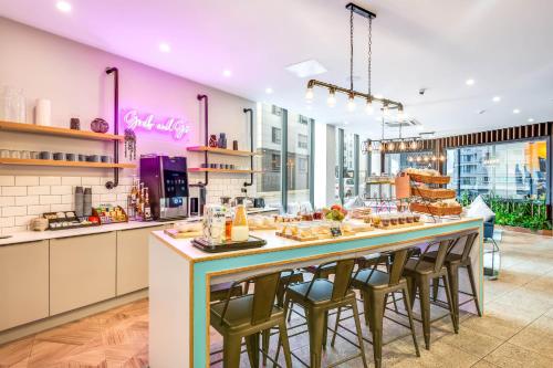 a kitchen with a large counter with bar stools at The Edge in Central Station
