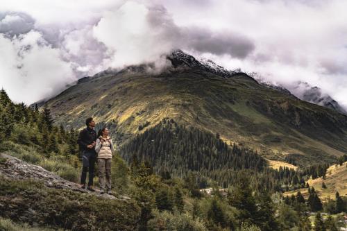 a man and a woman standing on top of a mountain at Verwöhnhotel Wildspitze in Sankt Leonhard im Pitztal