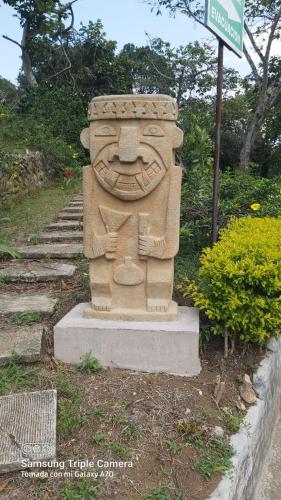 a statue of a face on the side of a street at San Agustin Internacional Hotel in San Agustín