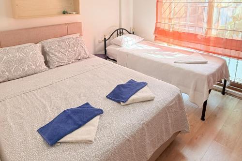 two beds in a room with towels on them at Villa Ahmet Dalyan 4 bedrooms in Dalyan