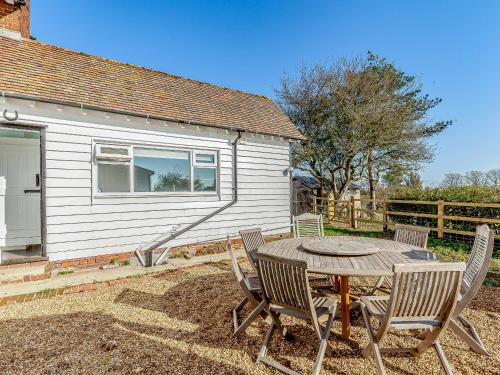 a table and chairs in front of a house at Mark Farmhouse in Bradwell on Sea