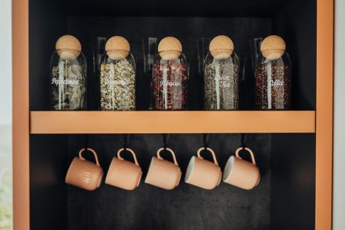 a shelf with glass bottles withiboiboibo at Lake View stay, stunning sunrises & free parking in Liepāja