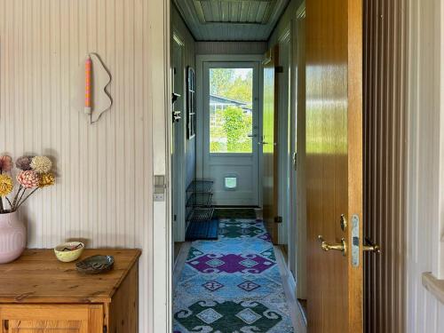 a hallway with a door and a tile floor at Colourful Holiday Home Near Middelfart Beach in Voldby
