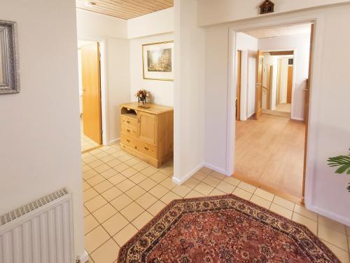a hallway of a home with a dresser and a room at Paddock House in Middleham