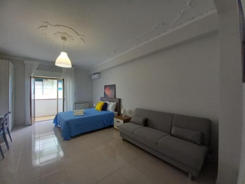 a living room with a bed and a couch at Casa Sapio vista mare in Pace Inferiore