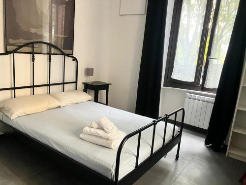 a bedroom with a bed with white towels on it at Porta Susa Rooms in Turin