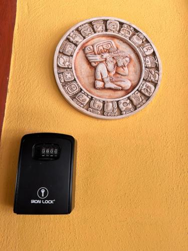 a coin on the wall next to a remote control at The Diving Lodge Downtown in Puerto Morelos