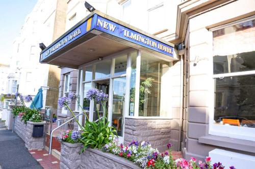 a shop with a sign on the front of it at New Wilmington Hotel in Eastbourne