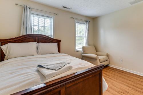 a bedroom with a large bed and a chair at Classic Colonial Home with Private Yard in Richmond! in Beulah Village