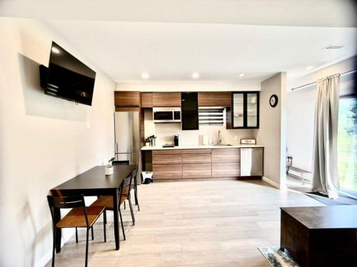 a kitchen and dining room with a table and chairs at The Simple Escape, Walkout Basement on Ravine in Kitchener